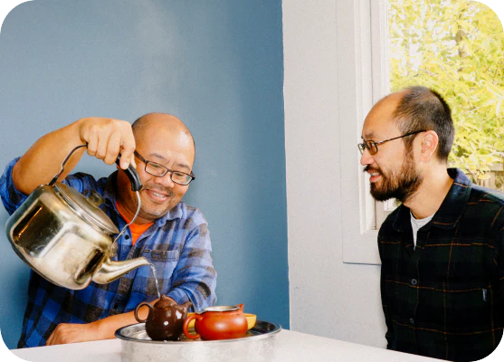 Two founders pouring tea